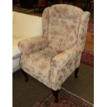 A modern wingback chair with floral upholstery