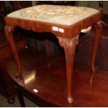 A mahogany piano stool with wool work seat cover