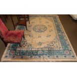 Chinese rug, circa 1920, the champagne field centred by a floral medallion surrounded by sprigs,