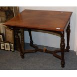 A mahogany side table on turned legs and a shaped stretcher