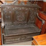 A late Victorian carved oak two-seater settle