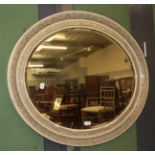 An early 20th century oval floral decorated wall mirror