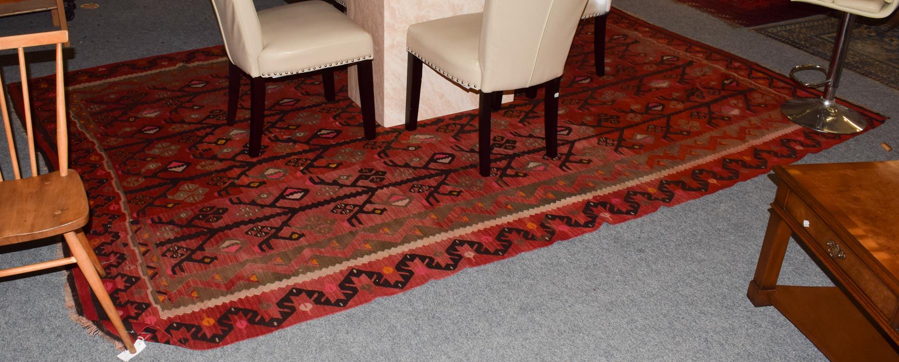 Large Anatloian Kilim, the tomato red field with a one way design of angular trees enclosed by