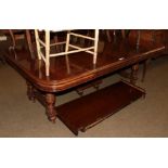 A 20th century mahogany stained extending dining table with four extra leaves