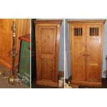 An oak cupboard with grill doors 103cm by 51cm by 211cm together with a single pine wardrobe and a