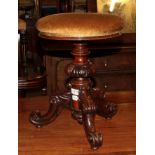 A Victorian rosewood revolving piano stool on cabriole tripod support