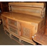 An early 20th century carved oak buffet back sideboard with pineapple carved legs