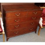 An early 19th century oak four-height chest of drawers