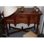 A reproduction three-drawer side table