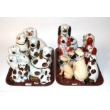 Two trays of 19th century Staffordshire seated spaniels and pugs