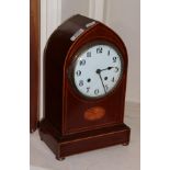 An Edwardian inlaid mahogany striking mantel clock