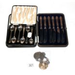 A cased set of silver coffee spoons, Birmingham; a cased set of butter knives, silver handled; three