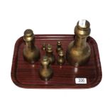 A set of eight brass graduated weights