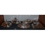 Five various silver plated entree dishes with covers and handles, together with one base