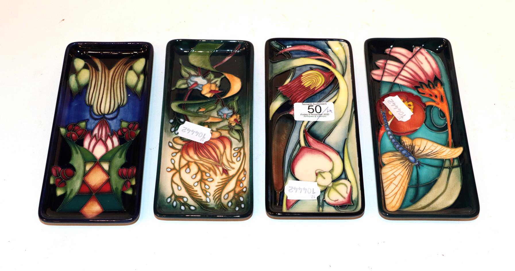 Four various Moorcroft pen trays . 20cm by 9cm. Good condition. All first quality.