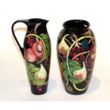 A Moorcroft pomegranate pattern vase and ewer (2) (a.f.) . Ewer - Cracks to the handle and signs