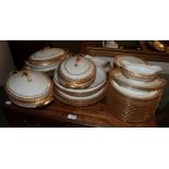 A quantity of Limoges gilt decorated dinner wares including three tureens and three oval platters