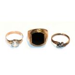 An onyx signet ring, stamped '333', finger size U1/2; a colourless paste ring, unmarked, finger size