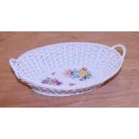 A 20th century Meissen porcelain basket, with twin handles and painted with floral sprays