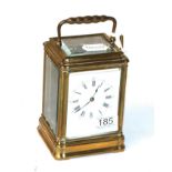 A French brass carriage clock, enamel Roman and Arabic dial, with key, movement back plate stamped H
