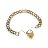 A curb link bracelet, stamped '9' and '.375', with a 9 carat gold heart shaped padlock clasp, length