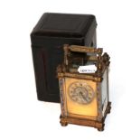 A French brass and champleve enamel carriage timepiece circa 1900 with fitted travelling case . Side