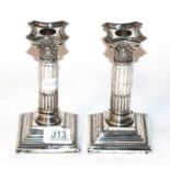 A pair of silver Corinthian candlesticks, by Nathan & Hayes, Birmingham & Chester marks, (a.f.) 17cm