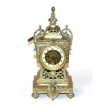 A gilt metal striking mantel clock