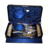 An eight-piece silver dressing table set, Birmingham marks, inscribed 'Amy', case, with key