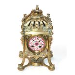 A gilt metal striking mantel clock, pink porcelain dial, movement stamped Hy Marc Paris