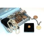 A small quantity of costume jewellery including plated chains, a simulated pearl necklace, a