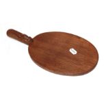 Workshop of Robert 'Mouseman' Thompson, an oval oak cheese board with carved mouse signature