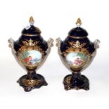 A pair of Sevres style blue ground gilt decorated porcelain vases and covers