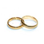 A 22 carat gold band ring, finger size N and a 9 carat gold band ring, finger size P1/2. 22 carat