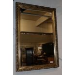 A reproduction gilt bevel glass mirror, 96cm by 66cm