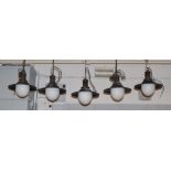 A set of five industrial design pendant ceiling lights each with opaque dome glass and blued metal