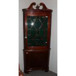 A 19th century mahogany floor standing glazed corner cupboard