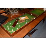 A 19th century mahogany folding bar bagatelle table with two cues and nine balls