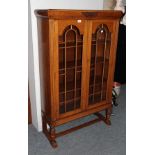 A 1920's oak bookcase and a matching bureau