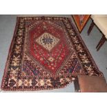 A Kashgai rug, the strawberry field centred by a hut medallion, framed by ivory bordered, 206 by