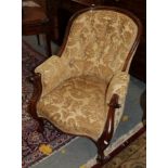 A Victorian carved mahogany button-back armchair