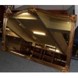 A reproduction large gilt frame over-mantle mirror, 114cm by 183cm