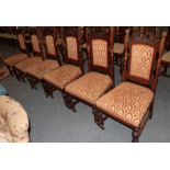 A set of six late Victorian carved oak and upholstered dining chairs