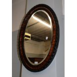 A mahogany oval mirror, 87cm by 62cm