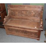 A Victorian carved oak monks' bench, 127cm by 46cm by 99cm high