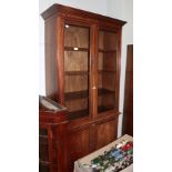 A mahogany glazed bookcase with adjustable shelves and cupboard doors, 91cm by 40cm by 202cm; and