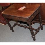 A Victorian carved oak library table with two small drawers, turned legs and H-stretcher, 95cm by