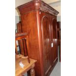 A Victorian mahogany double door wardrobe, with moulded panel doors, the interior with hanging space