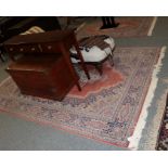 A machine made carpet the field with central medallion framed by indigo borders, 397cm by 297cm,