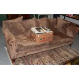 A Kingsley & Co modern three-seater sofa covered in brown corduroy style fabric with scatter